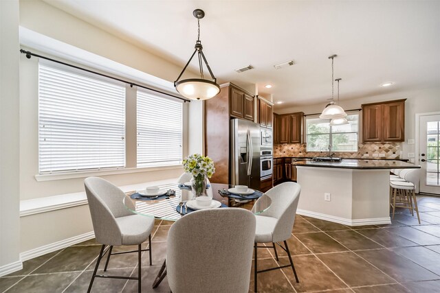 7319 Fair Meadow Ln, Katy, TX 77494 - dining area with dark tile patterned floors, baseboards, and recessed lighting