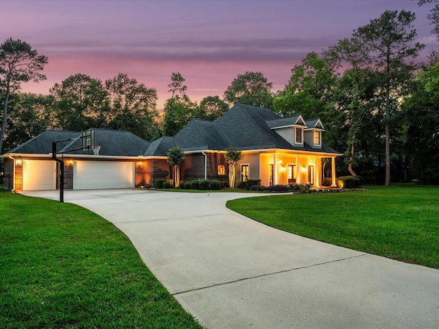 9810 Clubhouse Cir, Magnolia, TX 77354 - view of front of home featuring concrete driveway, an attached garage, a front yard, and brick siding