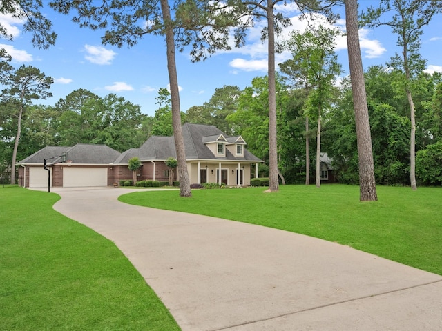 9810 Clubhouse Cir, Magnolia, TX 77354 - view of front of property featuring concrete driveway, a front lawn, an attached garage, and view of scattered trees