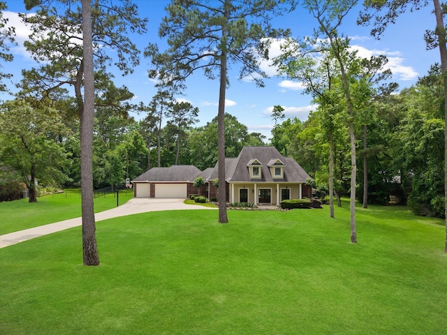 9810 Clubhouse Cir, Magnolia, TX 77354 - view of front of property featuring concrete driveway, a front yard, an attached garage, covered porch, and view of scattered trees