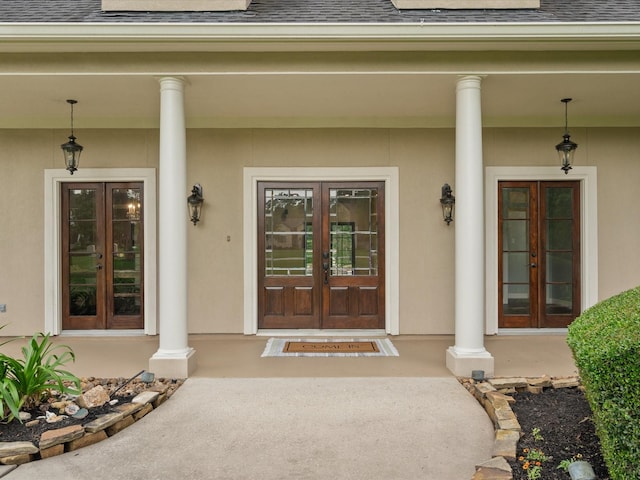 9810 Clubhouse Cir, Magnolia, TX 77354 - doorway to property with french doors, a shingled roof, and covered porch
