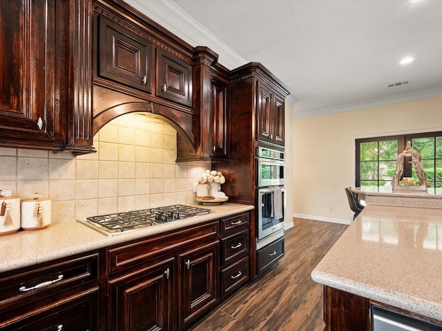 9810 Clubhouse Cir, Magnolia, TX 77354 - kitchen with appliances with stainless steel finishes, ornamental molding, baseboards, dark wood finished floors, and tasteful backsplash