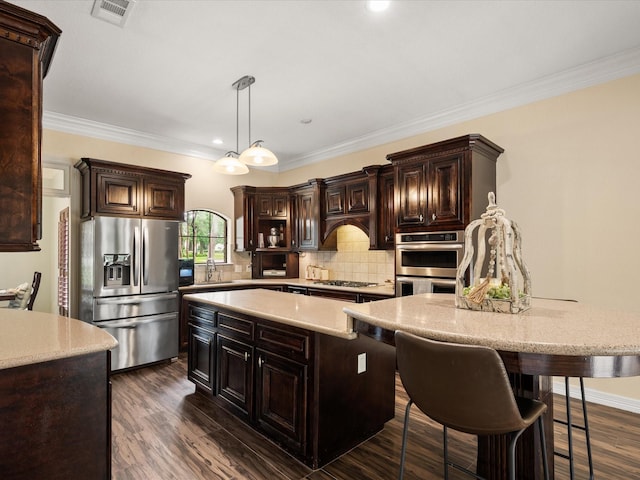 9810 Clubhouse Cir, Magnolia, TX 77354 - kitchen featuring appliances with stainless steel finishes, a sink, a center island, backsplash, and dark brown cabinets