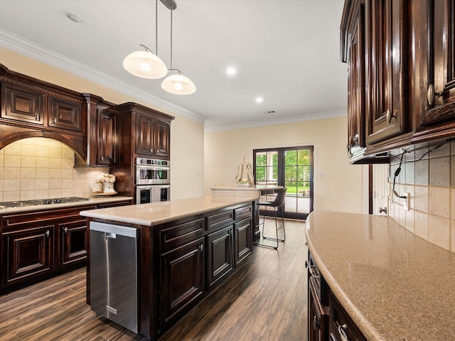 9810 Clubhouse Cir, Magnolia, TX 77354 - kitchen with appliances with stainless steel finishes, dark wood-style flooring, backsplash, crown molding, and pendant lighting