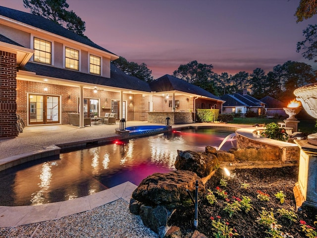 9810 Clubhouse Cir, Magnolia, TX 77354 - view of swimming pool featuring french doors, a pool with connected hot tub, and a patio area