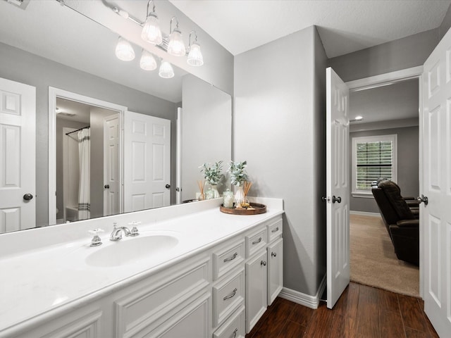 9810 Clubhouse Cir, Magnolia, TX 77354 - bathroom with vanity, baseboards, and wood finished floors