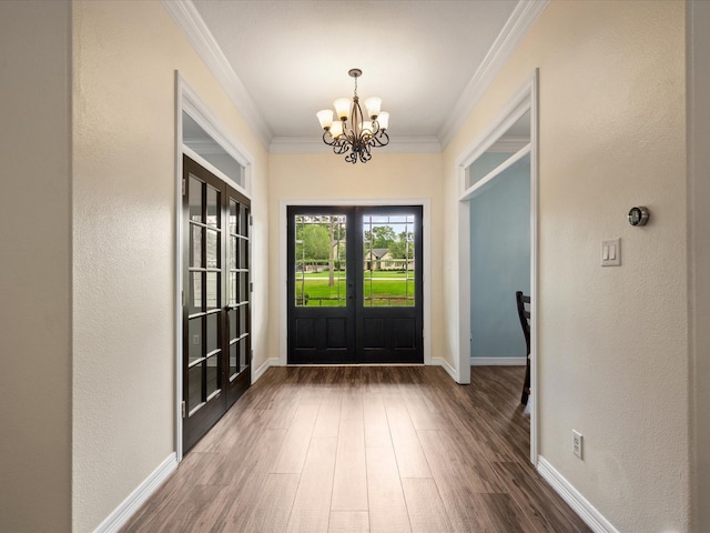 9810 Clubhouse Cir, Magnolia, TX 77354 - entryway featuring french doors, a chandelier, wood finished floors, ornamental molding, and baseboards
