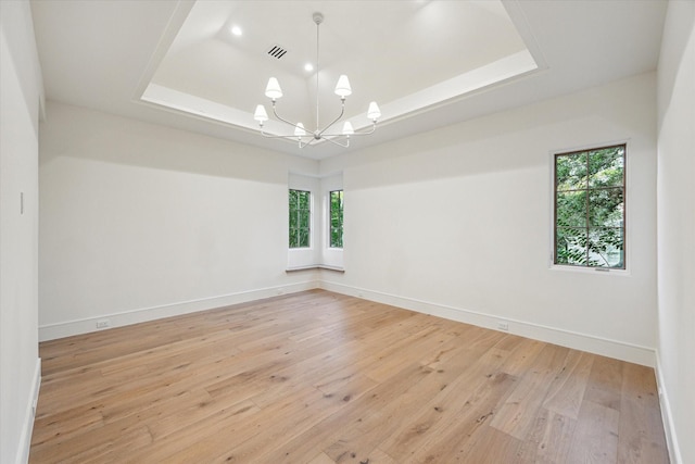 3755 Rice Blvd, Houston, TX 77005 - spare room with a raised ceiling, healthy amount of natural light, a chandelier, and light wood finished floors
