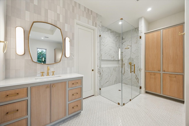 3755 Rice Blvd, Houston, TX 77005 - bathroom featuring a marble finish shower, vanity, and decorative backsplash