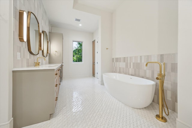 3755 Rice Blvd, Houston, TX 77005 - bathroom featuring tile walls, vanity, a freestanding tub, and a wainscoted wall