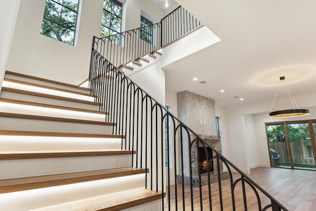 3755 Rice Blvd, Houston, TX 77005 - stairs with wood finished floors, recessed lighting, a high ceiling, and baseboards
