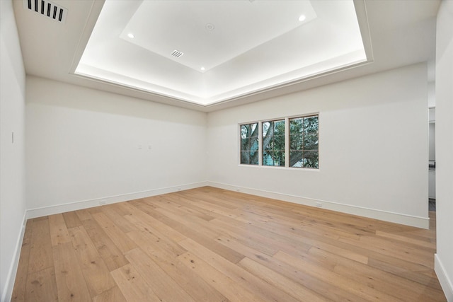 3755 Rice Blvd, Houston, TX 77005 - spare room with a tray ceiling, hardwood / wood-style flooring, baseboards, and recessed lighting