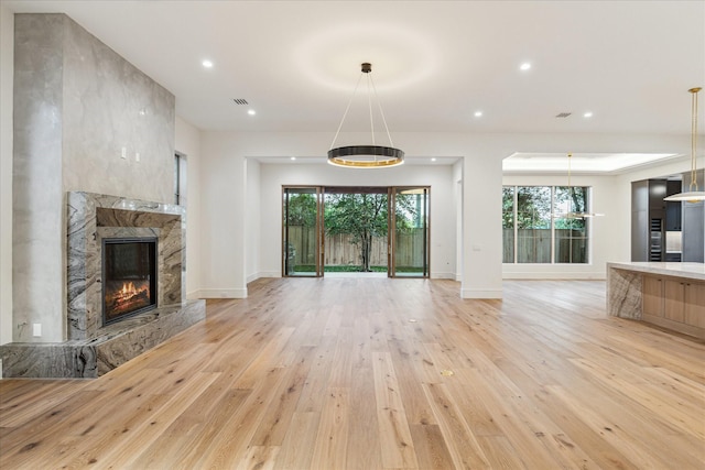 3755 Rice Blvd, Houston, TX 77005 - unfurnished living room with light wood-style floors, a fireplace, baseboards, and recessed lighting
