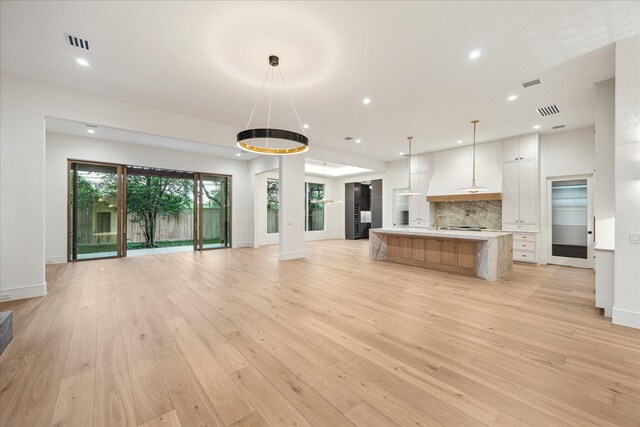 3755 Rice Blvd, Houston, TX 77005 - unfurnished living room with baseboards, light wood-type flooring, and recessed lighting