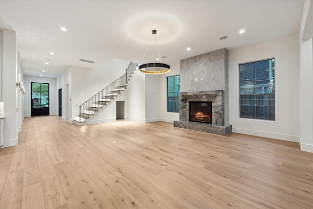 3755 Rice Blvd, Houston, TX 77005 - unfurnished living room featuring stairs, light wood finished floors, recessed lighting, baseboards, and a fireplace
