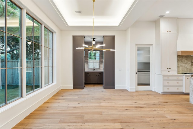 3755 Rice Blvd, Houston, TX 77005 - unfurnished dining area with light wood-type flooring, a sink, a raised ceiling, baseboards, and recessed lighting