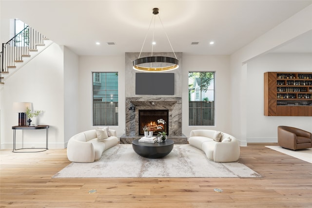 3755 Rice Blvd, Houston, TX 77005 - living room featuring wood finished floors, baseboards, recessed lighting, a premium fireplace, and stairway