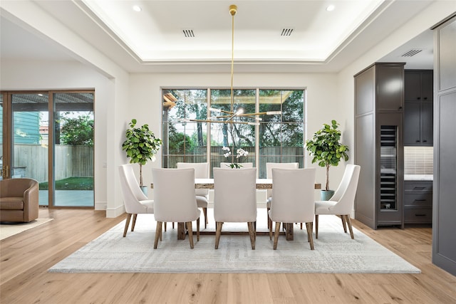 3755 Rice Blvd, Houston, TX 77005 - dining space with a tray ceiling, a chandelier, plenty of natural light, wood finished floors, and recessed lighting