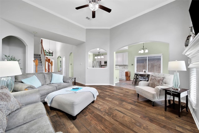 12010 Piney Bend Dr, Tomball, TX 77375 - living room featuring a chandelier, arched walkways, a ceiling fan, ornamental molding, and dark wood-style flooring