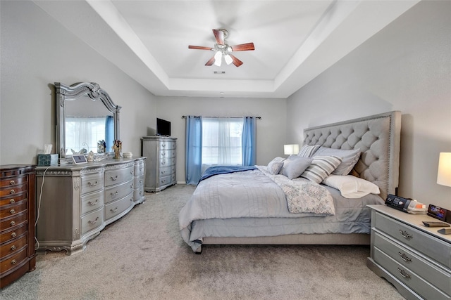 12010 Piney Bend Dr, Tomball, TX 77375 - bedroom with light colored carpet, a raised ceiling, and ceiling fan