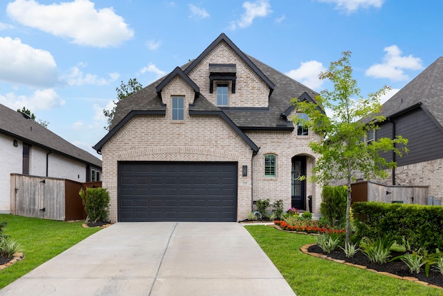 221 Sky Top Dr, Montgomery, TX 77316 - french country inspired facade featuring brick siding, a front lawn, and concrete driveway