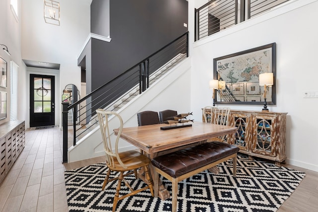 221 Sky Top Dr, Montgomery, TX 77316 - dining room with a towering ceiling, wood finished floors, stairs, and baseboards