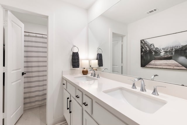 221 Sky Top Dr, Montgomery, TX 77316 - bathroom featuring double vanity and marble finish flooring