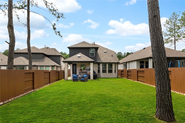 221 Sky Top Dr, Montgomery, TX 77316 - back of house featuring brick siding, roof with shingles, and an outdoor hangout area