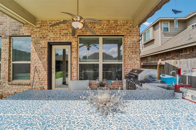 129 S Bearkat Ct, Montgomery, TX 77316 - view of exterior entry with brick siding, ceiling fan, and a sink