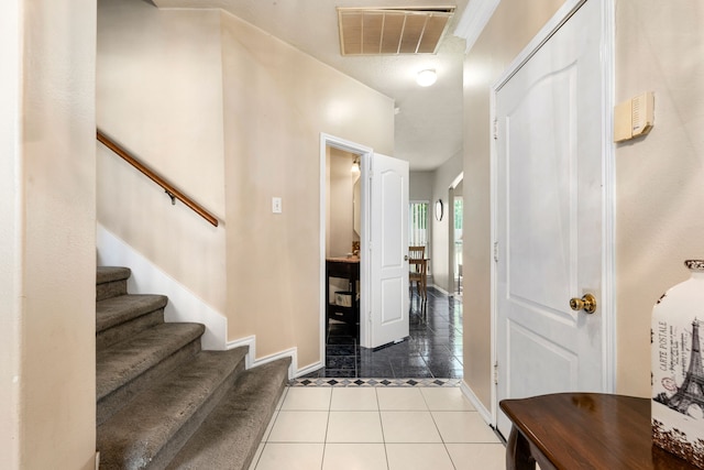 4907 Sienna Heights Ln, Pasadena, TX 77505 - foyer with tile patterned floors, baseboards, and stairs