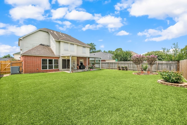 4907 Sienna Heights Ln, Pasadena, TX 77505 - back of property featuring brick siding, a patio, central AC, and a shingled roof