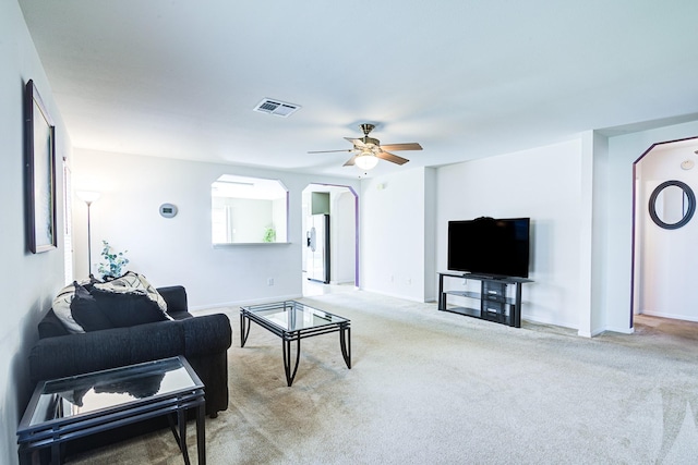 3403 Wheatfield Ct, Pearland, TX 77581 - carpeted living room featuring arched walkways, ceiling fan, and baseboards