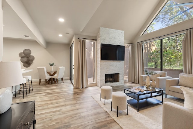 137 Litchfield Ln, Houston, TX 77024 - living room featuring wood finished floors, recessed lighting, a stone fireplace, high vaulted ceiling, and baseboards