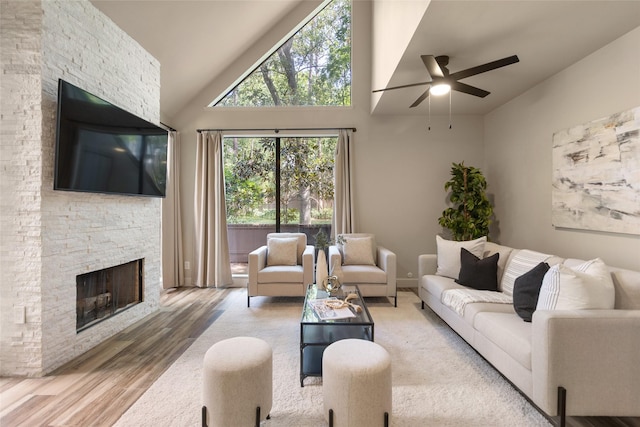 137 Litchfield Ln, Houston, TX 77024 - living area featuring a ceiling fan, wood finished floors, a fireplace, and high vaulted ceiling