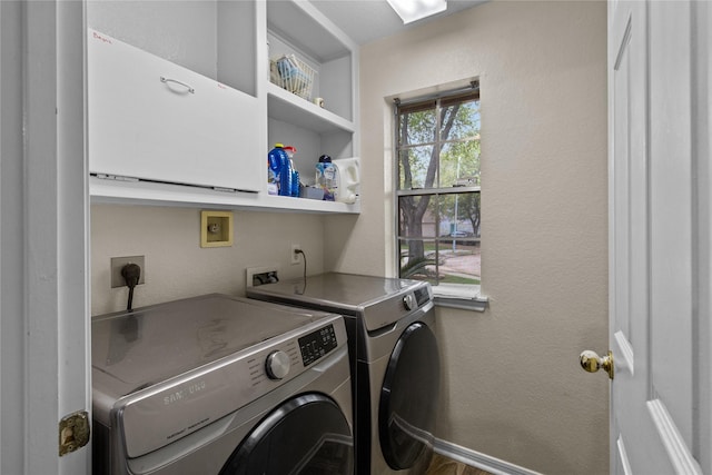 5523 Waverdale Ct, Sugar Land, TX 77479 - laundry area featuring washer and clothes dryer, cabinet space, and a textured wall