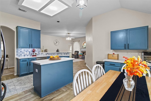 5523 Waverdale Ct, Sugar Land, TX 77479 - kitchen with blue cabinetry, light countertops, a ceiling fan, a sink, and a center island