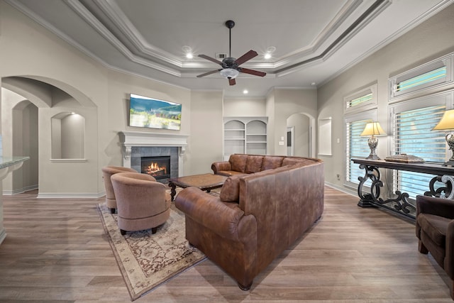 261 Ridge Lake Dr, Montgomery, TX 77316 - living room featuring a fireplace, wood finished floors, ornamental molding, ceiling fan, and baseboards