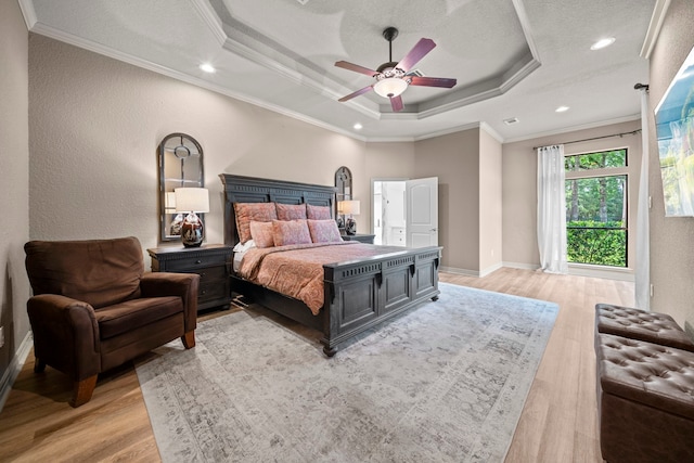261 Ridge Lake Dr, Montgomery, TX 77316 - bedroom with a raised ceiling, light wood-style flooring, ornamental molding, baseboards, and a ceiling fan