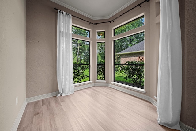 261 Ridge Lake Dr, Montgomery, TX 77316 - empty room with healthy amount of natural light, a textured wall, wood finished floors, ornamental molding, and baseboards