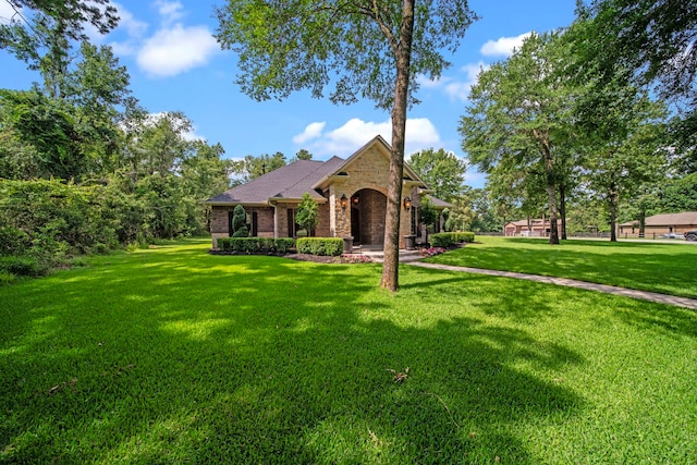 261 Ridge Lake Dr, Montgomery, TX 77316 - view of front of home featuring a front lawn, brick siding, and stone siding