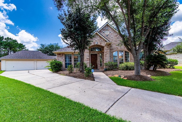 2207 Desert Vine Ct, Sugar Land, TX 77498 - view of front of home featuring brick siding, a front lawn, driveway, and a detached garage
