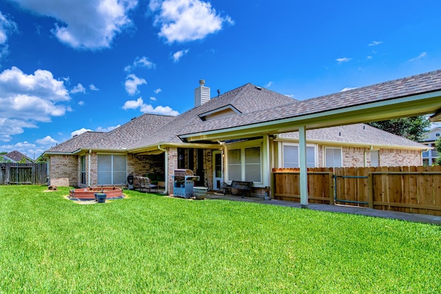 2207 Desert Vine Ct, Sugar Land, TX 77498 - back of house with roof with shingles, brick siding, a patio area, and a chimney