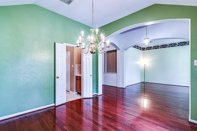 2207 Desert Vine Ct, Sugar Land, TX 77498 - empty room with vaulted ceiling, arched walkways, wood finished floors, a chandelier, and baseboards
