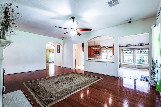 2207 Desert Vine Ct, Sugar Land, TX 77498 - living area featuring arched walkways, ceiling fan, and wood finished floors