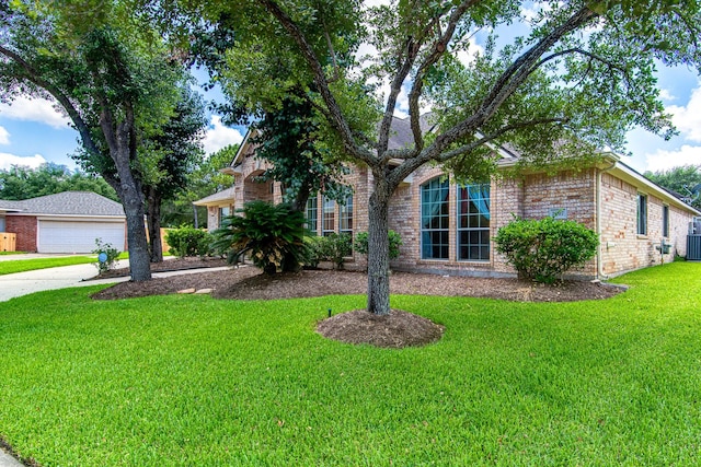 2207 Desert Vine Ct, Sugar Land, TX 77498 - view of front of property with brick siding, a front lawn, a detached garage, central air condition unit, and concrete driveway
