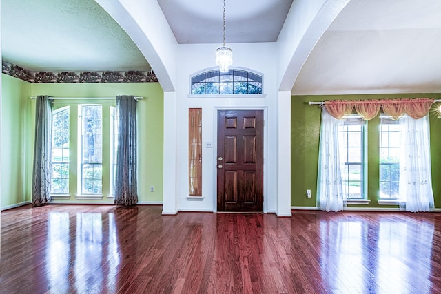 2207 Desert Vine Ct, Sugar Land, TX 77498 - entryway featuring wood finished floors, a chandelier, baseboards, and arched walkways