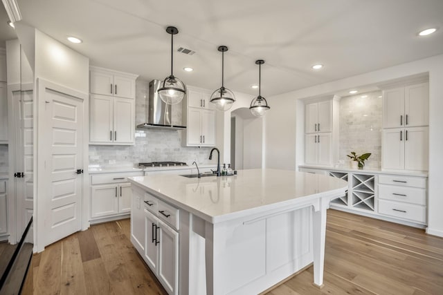 3111 Lantana Trl, Katy, TX 77493 - kitchen with wall chimney exhaust hood, a sink, backsplash, white cabinetry, and recessed lighting