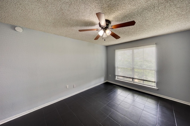 250 El Dorado Blvd Unit 103, Houston, TX 77598 - spare room with ceiling fan, a textured ceiling, dark tile patterned flooring, a smoke detector, and baseboards