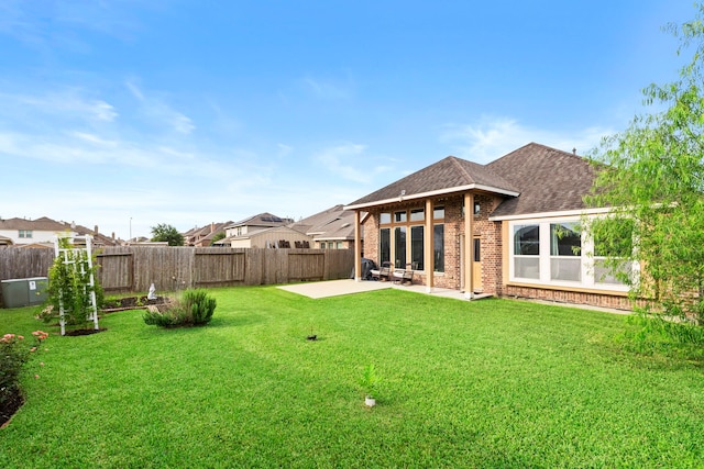 4914 Applewood Crest Ln, Rosharon, TX 77583 - back of house featuring a patio, roof with shingles, brick siding, and a fenced backyard