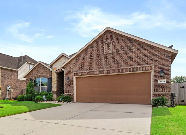 4914 Applewood Crest Ln, Rosharon, TX 77583 - view of front of house featuring brick siding, driveway, an attached garage, and stone siding